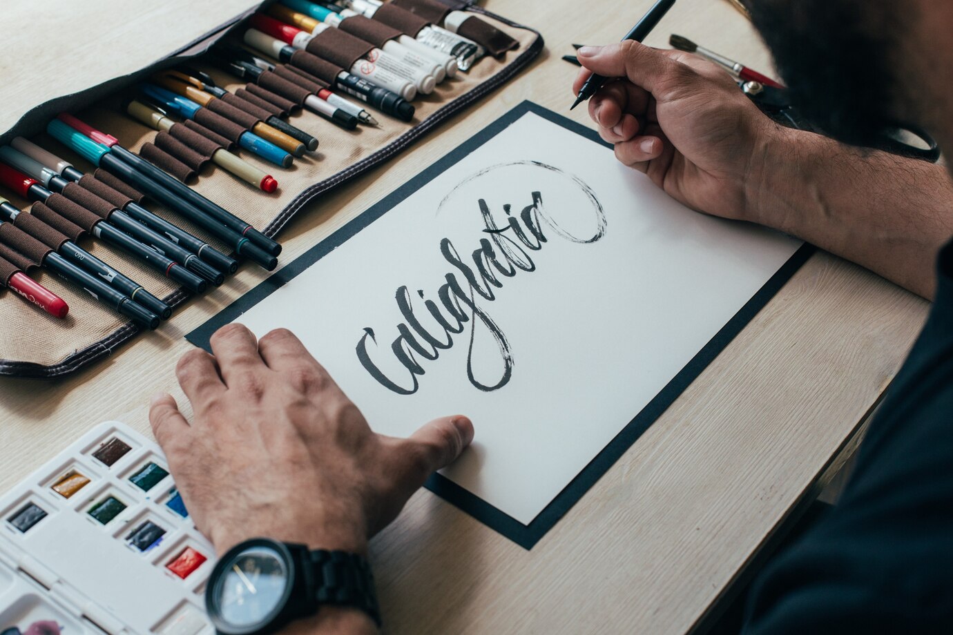 hipster-young-illustrator-artist-black-simple-tshirt-creates-authentic-unique-hand-lettering-drawing-his-bright-industrial-studio_346278-332